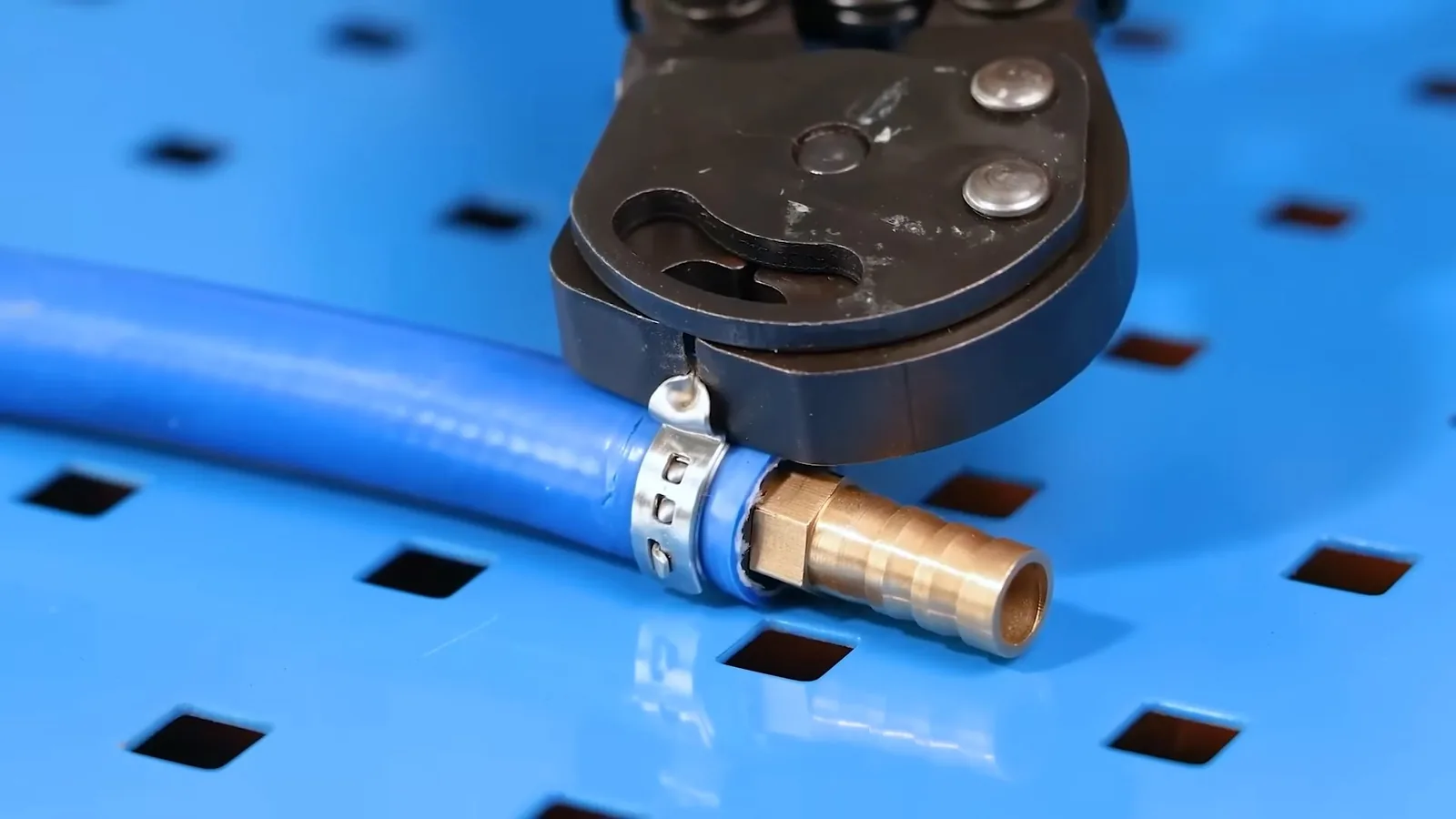 Blue pipe cutter and short metal pipe on a Brighton-area general pipe work job
