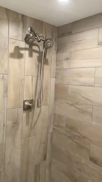 Finished shower with glass door and tiles, part of a bathroom plumbing call in the Brighton area