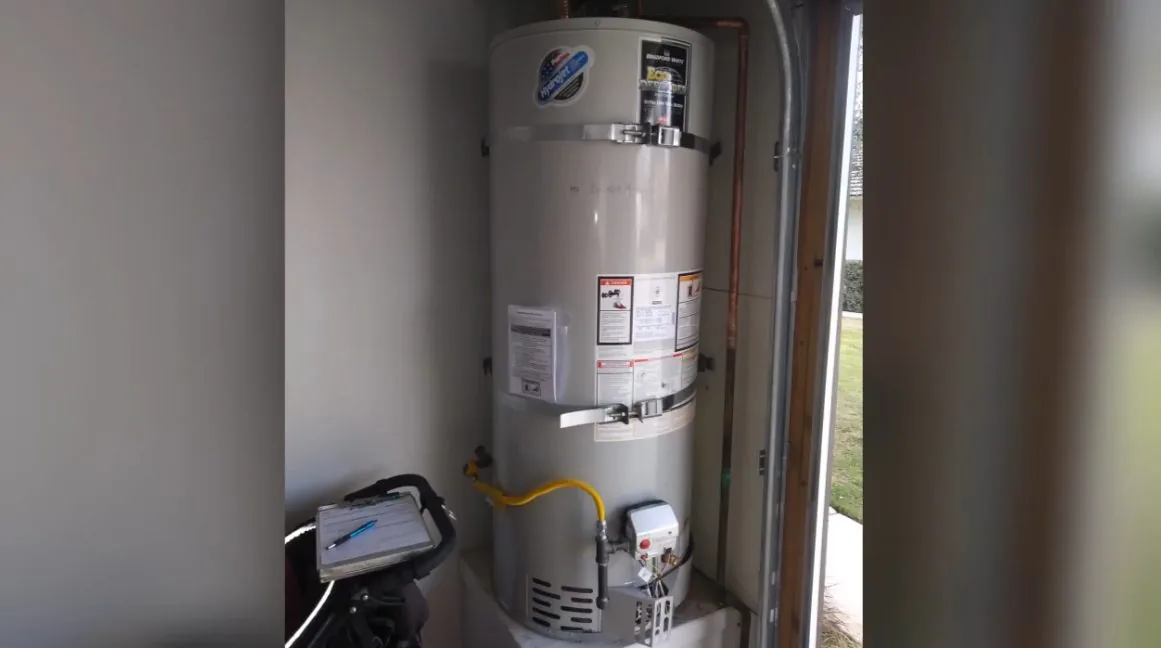 Water heater inside utility closet during a water heater service visit in Brighton, CO